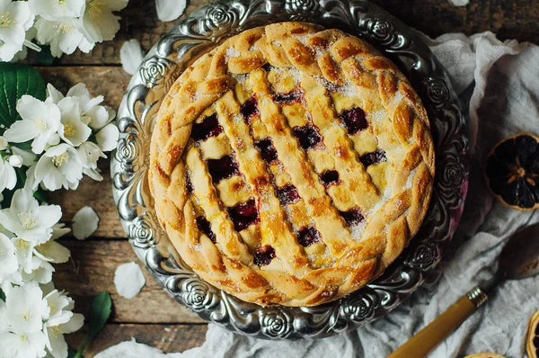 Homemade cherry and strawberry  pie on rustic background. Delici