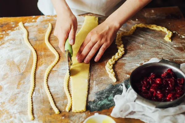 Ingredients for baking cake stuffed with fresh cherry pie. Female preparing cherry pie. Rustic dark style. See series recipe step on step. Womans hands. Recipe for homemade pie on short pastry