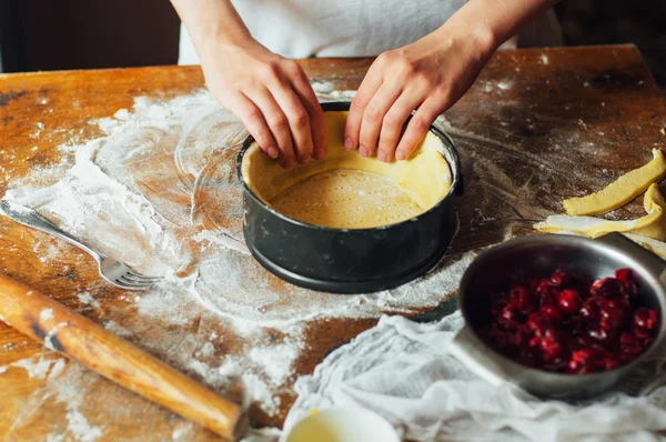 Ingredients for baking cake stuffed with fresh cherry pie. Female preparing cherry pie. Rustic dark style. See series recipe step on step. Womans hands. Recipe for homemade pie on short pastry