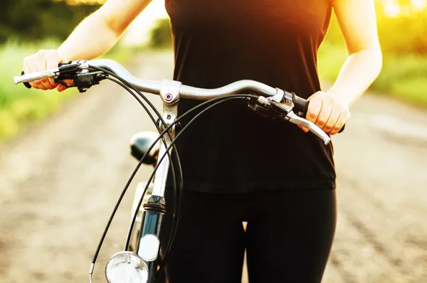 Detail of a bicycle. Woman riding her bicycle. Bicycle  on road