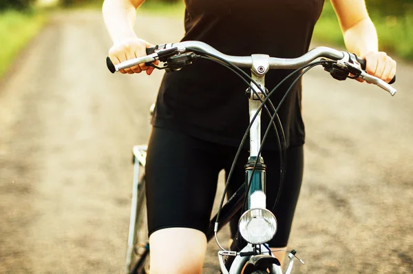 Detail of a bicycle. Woman riding her bicycle. Bicycle  on road