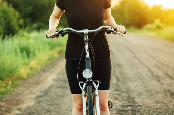 Detail of a bicycle. Woman riding her bicycle. Bicycle  on road