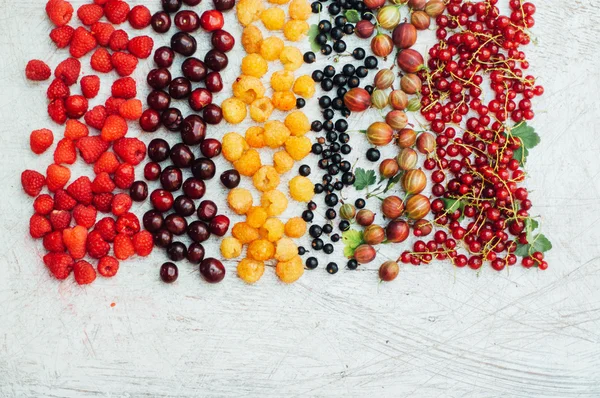 Colorful mix of fruits on black background. View from above. Fresh Organic Berries ,  so you can eat . Various fruit