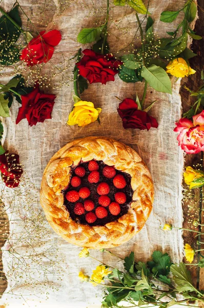 Tart with fresh berries.  Homemade  tart decorated with berries. Food: Cranberry and Raspberry upside down cake. a very natural and easy cake with olive oil and topped with caramelized raspberries