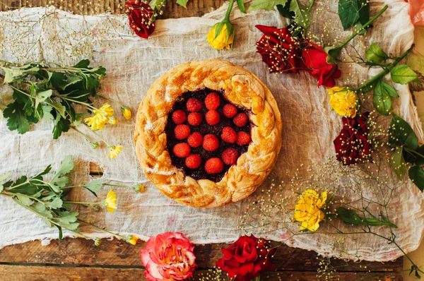 Tart with fresh berries.  Homemade  tart decorated with berries. Food: Cranberry and Raspberry upside down cake. a very natural and easy cake with olive oil and topped with caramelized raspberries