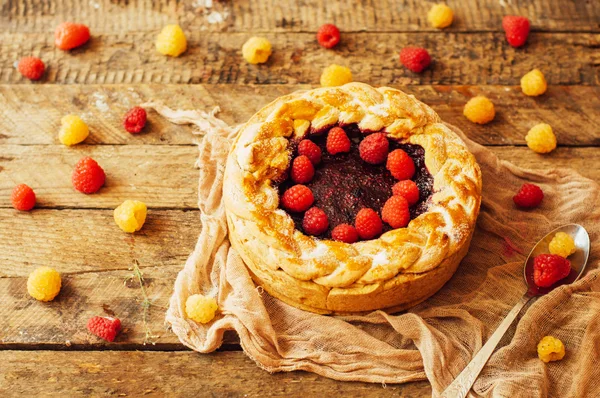 Tart with fresh berries.  Homemade  tart decorated with berries. Food: Cranberry and Raspberry upside down cake. a very natural and easy cake with olive oil and topped with caramelized raspberries