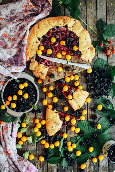 freshly baked berry pie. Blackberries pie with a slice missing.