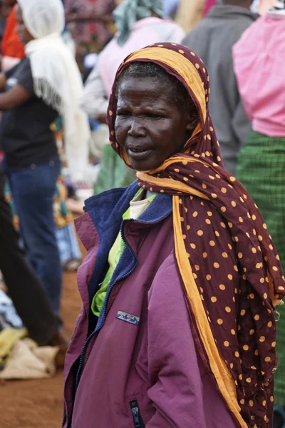 Portrait of African old woman on colourful clothes at Karatu Iraqw Market, Tanzania.