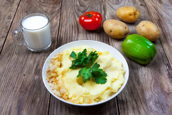 Mashed boiled potato with herbs. milk and vegetables