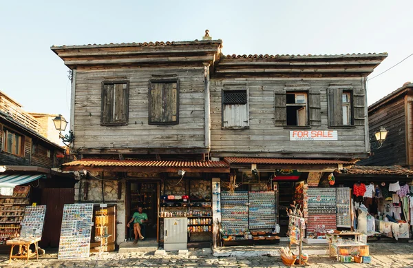 NESSEBAR, BULGARIA, AUGUST 31, 2015- Souvenirs\' seller sits in his shop in the old part of Nessebar. The ramshackle building for sale in Old Town.