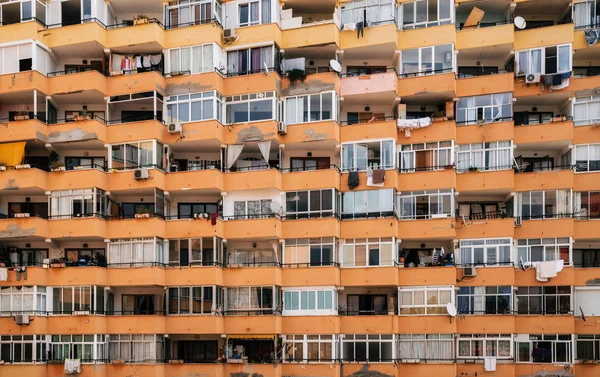 Texture of multistory house wall with balconies and windows