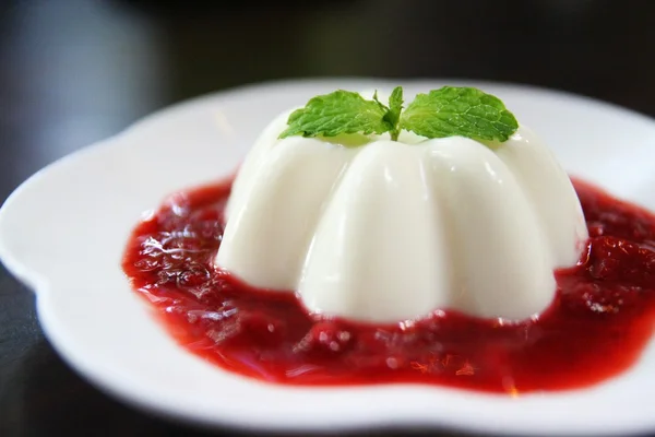 Panna cotta with raspberry sweet sauce and mint
