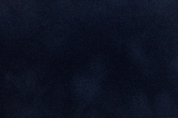 Dark blue suede fabric closeup. Velvet texture.
