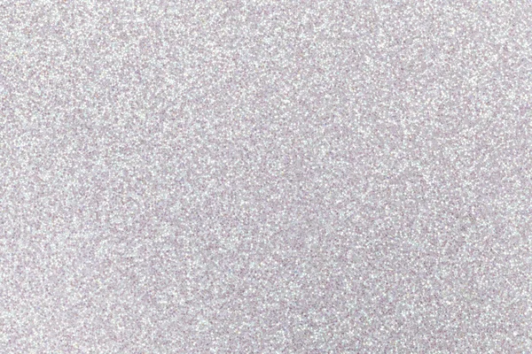 Sparkling background of white sparkles closeup.