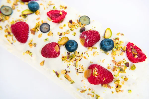 Cake with butter cream and raspberries on white background