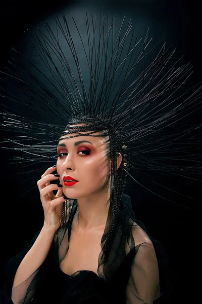 Woman with red lips and black crown