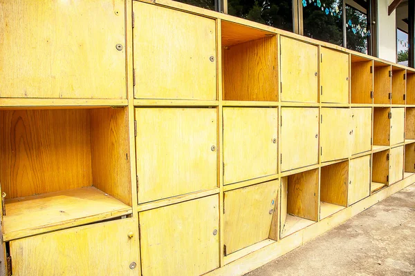 Row of wood locker in school with one is open