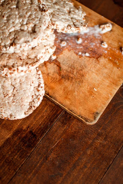 Tasty crispbread on wooden background table, spilled milk and crumbs