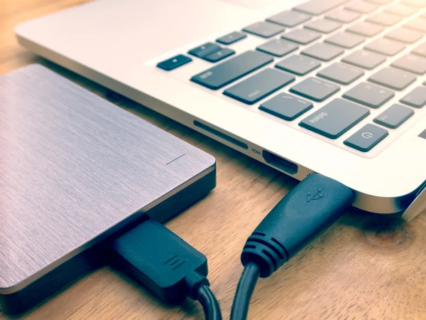 External hard drive connected to laptop computer