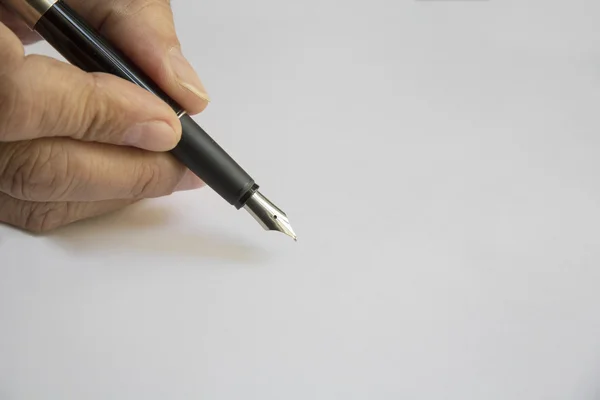 Hand holding a black pen with a pen in the position of writing
