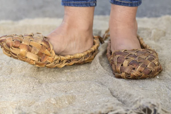 Feet girl in old Russian bast shoes