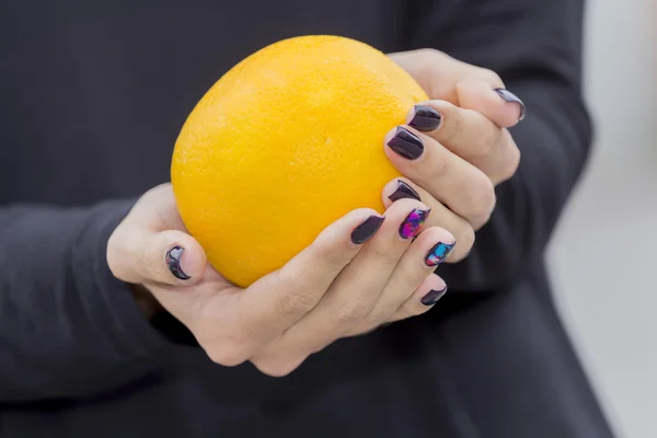 Girls hold hands orange.