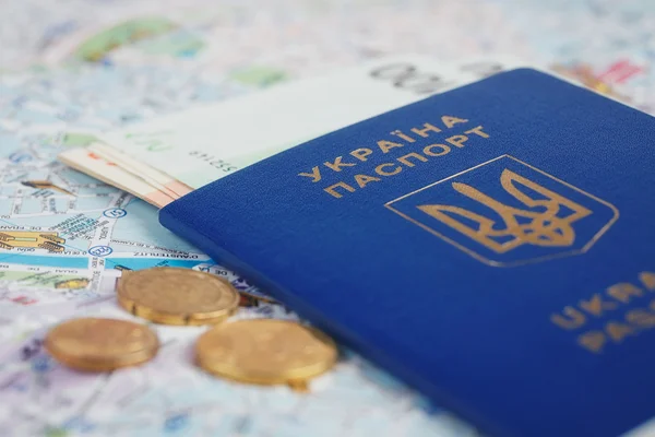 Travel and tourism concept: ukrainian passport and money on map