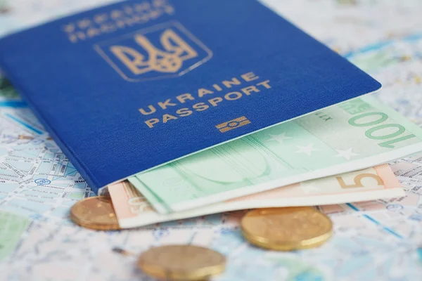 Travel and tourism concept: ukrainian passport and money on map
