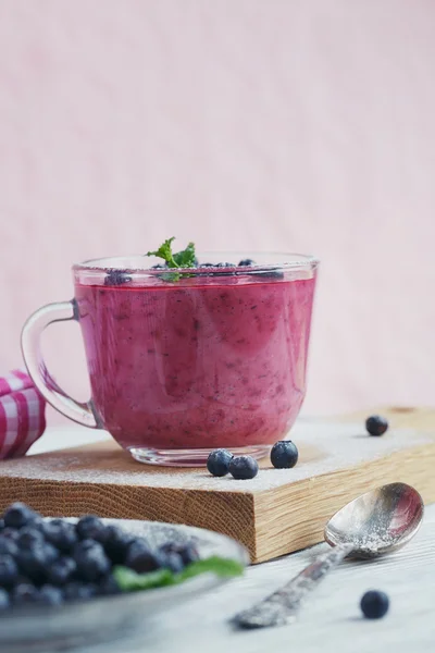 Delicious bilberry smoothie with fresh berries. Fresh yogurt wit