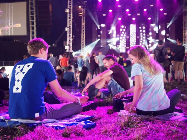 Crowd sittting watching music at festival