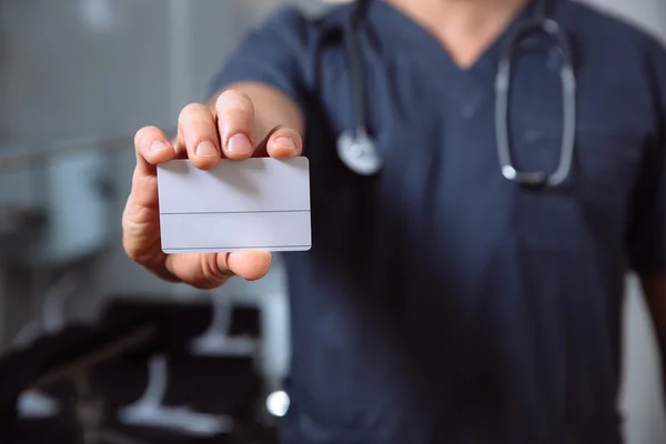Doctor holding a business card in hand