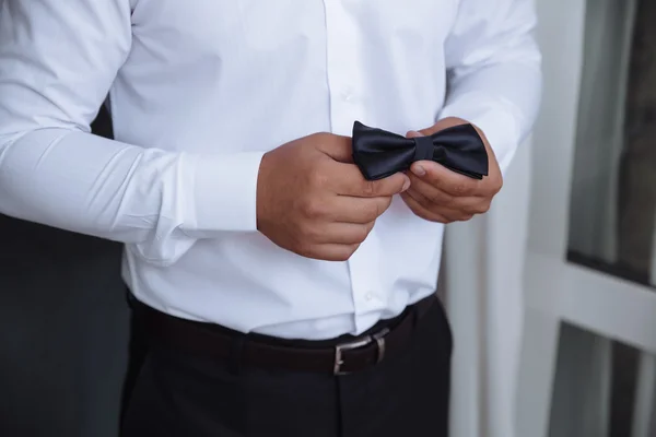 Man holding bow tie. Elegant gentleman clother.