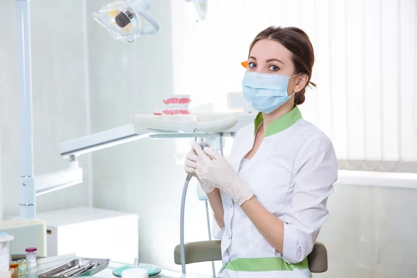 Young woman dentist at work in the office. Concept of healthy