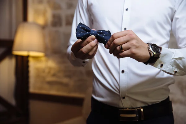 Man holding bow tie. Elegant gentleman clother.