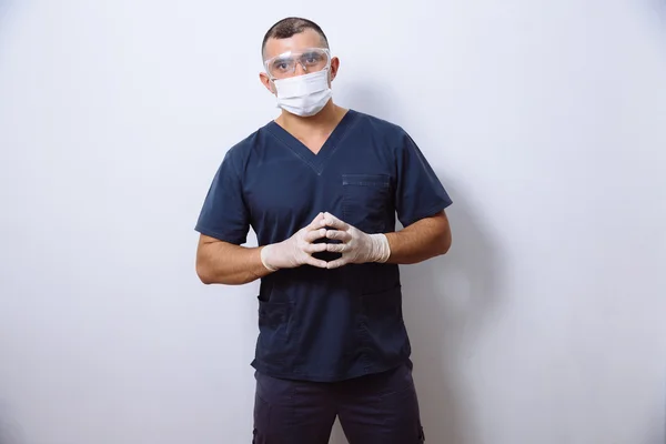 Portrait of young doctor with mask on a white background. Concept  surgery and healthy