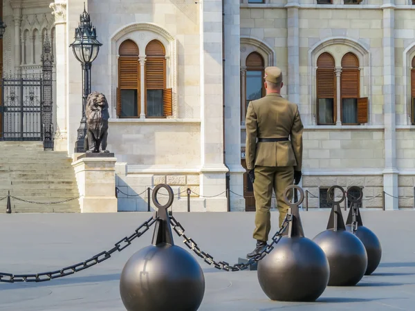 The Hungarian soldier standing on a check-post against the Hungarian Parliament building