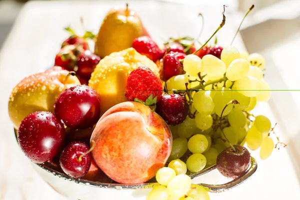 Fresh mixed fruits, berries in bowl. Love fruit, berry. Sunlight