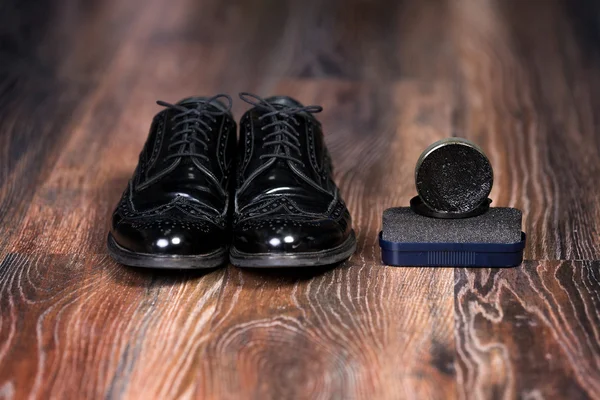 Black man's shoes with Shoe Polish and sponge for shoes