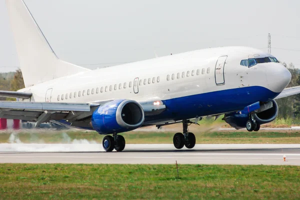 Airplane landing on runway. Touchdown with tire smoke