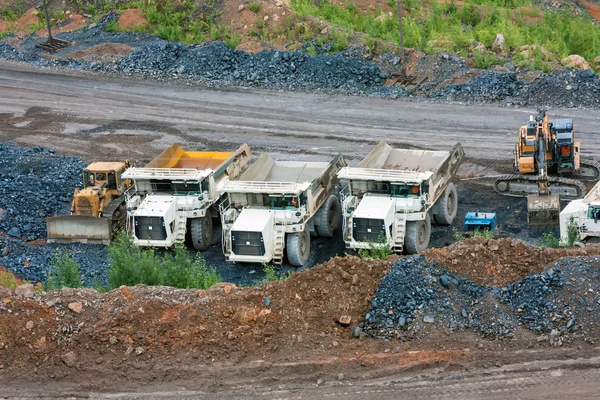 Bulldozer, dump trucks and excavator