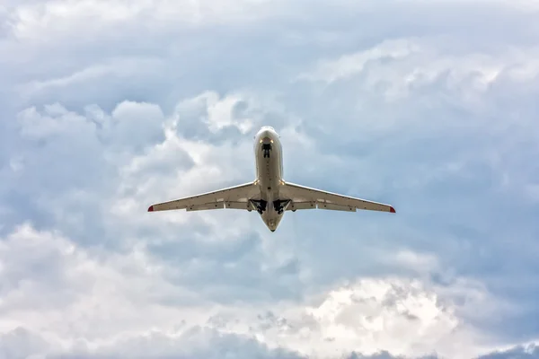 Airplane taking off in a somber sky