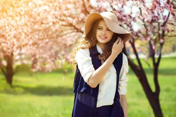 Spring woman in green garden enjoying the sunny day