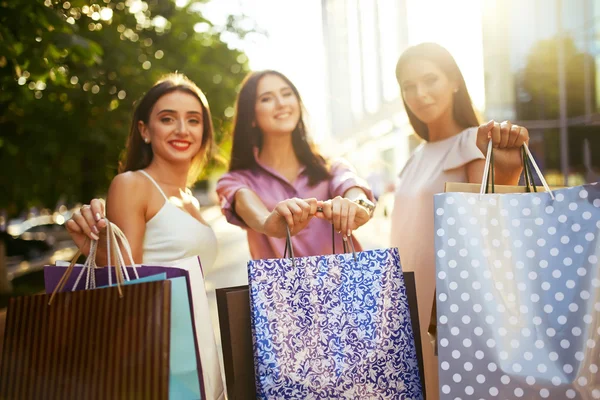 Beautiful girl with packages after shopping A picture of a group of happy friends shopping in the city. Girl walking around the city after shopping. good mood.