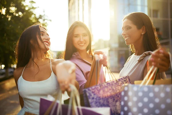 Beautiful girl with packages after shopping A picture of a group of happy friends shopping in the city. Girl walking around the city after shopping. good mood.