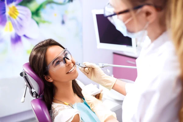 Overview of dental caries prevention.Woman at the dentist\'s chair during a dental procedure. Beautiful Woman smile