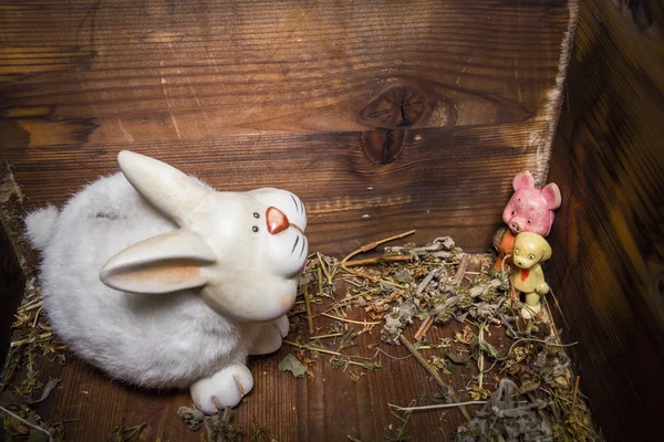 Old toys - rabbit, dog and pig in wooden chest