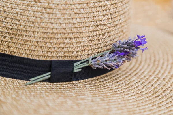 Lavender inserted in black ribbon on wicker straw flaxen hat