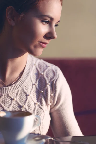 Young girl in a cozy cafe