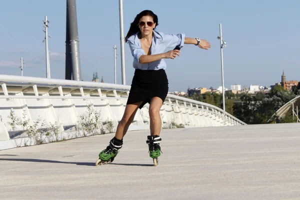 Woman skater speeding with a skirt