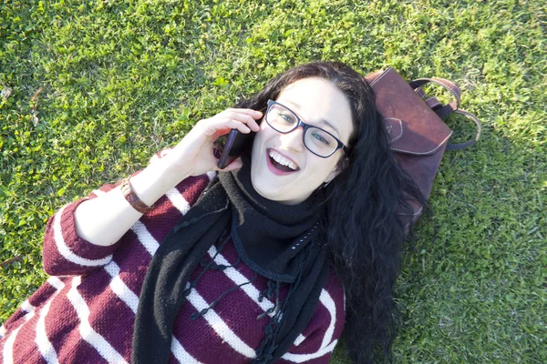 Woman talking by the phone with a friend